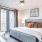 a bedroom with a bed and a fan