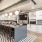 a kitchen with a bar and chairs