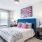 a bedroom with a bed and a fan