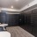 a room with a black cabinet and a white table