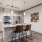 a kitchen with a bar and chairs