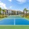 a tennis court with a building in the background