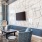 a living room with a wall of black and white tiles